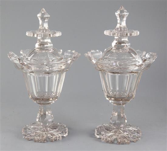 A pair of cut glass jars and covers, mid 19th century, 33cm, some damage